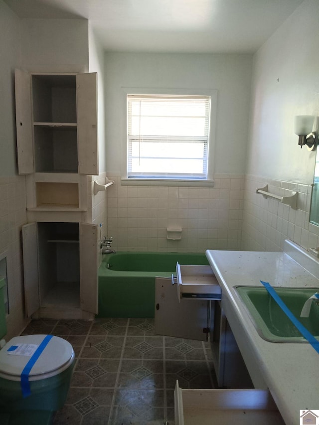 23 Piper, Clinton, KY 42031 - full bathroom featuring tile walls, a tub, a wainscoted wall, toilet, and tile patterned floors