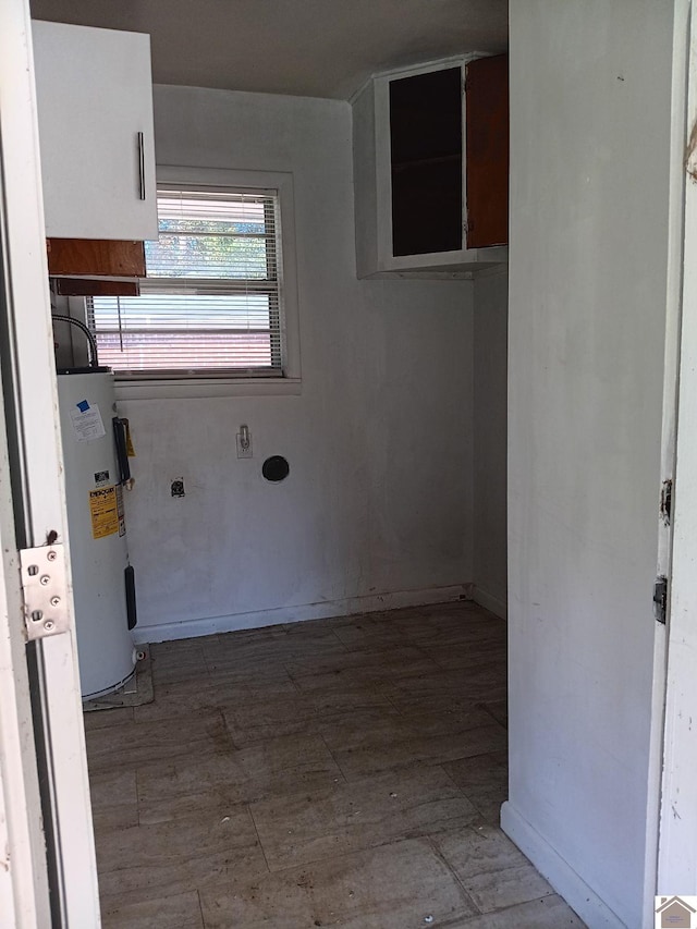 23 Piper, Clinton, KY 42031 - washroom with electric water heater, wood finished floors, and baseboards