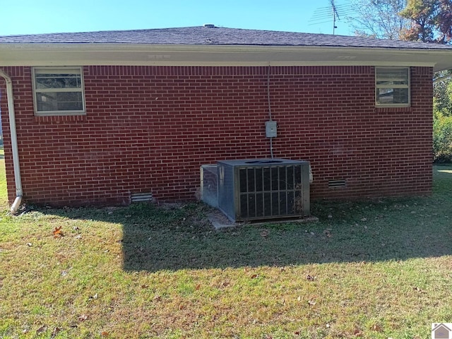 23 Piper, Clinton, KY 42031 - view of property exterior featuring central air condition unit, a lawn, and brick siding