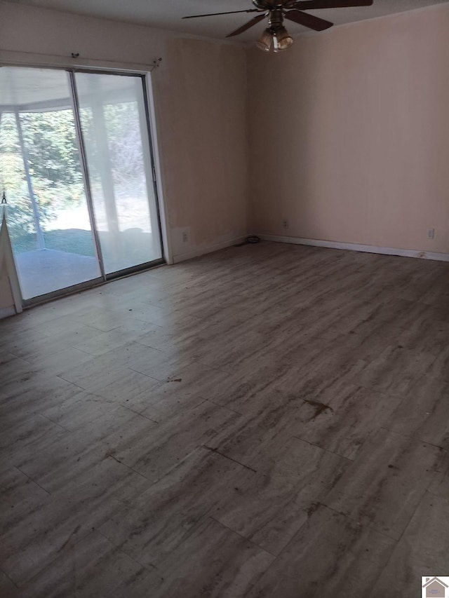 23 Piper, Clinton, KY 42031 - empty room featuring a ceiling fan, wood finished floors, and baseboards