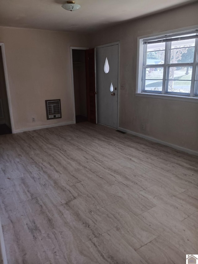 23 Piper, Clinton, KY 42031 - foyer entrance featuring baseboards, heating unit, and wood finished floors
