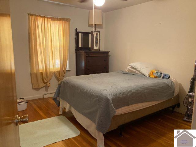 bedroom featuring ceiling fan and dark hardwood / wood-style flooring