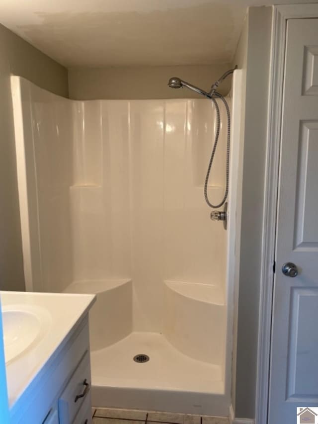 bathroom featuring vanity and a shower