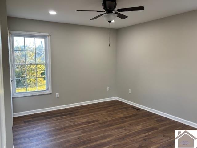 spare room with dark hardwood / wood-style floors and ceiling fan