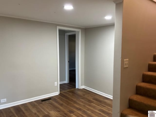 staircase with crown molding and wood-type flooring