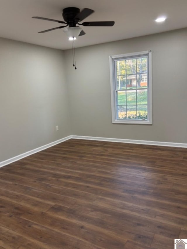 empty room featuring ceiling fan and dark hardwood / wood-style flooring