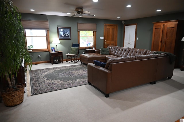 living room with ceiling fan and light colored carpet