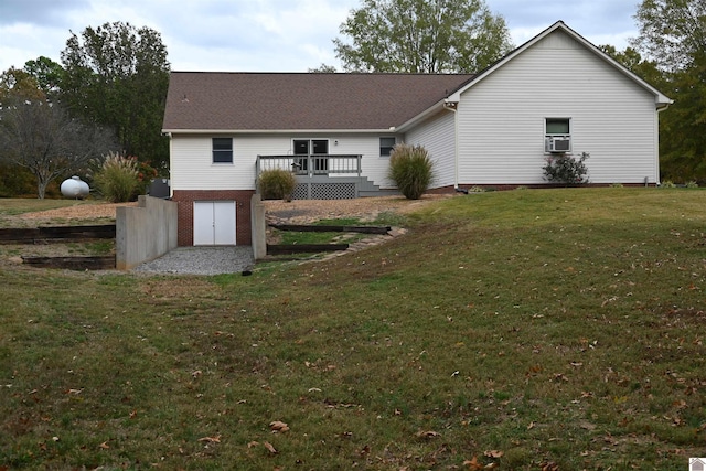 rear view of property with a yard and a wooden deck