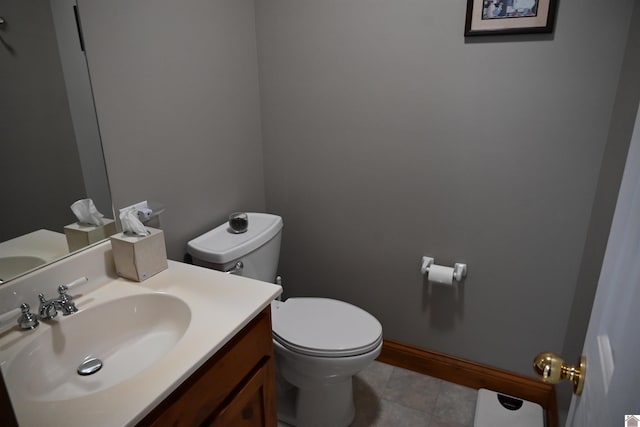 bathroom with vanity, toilet, and tile patterned flooring