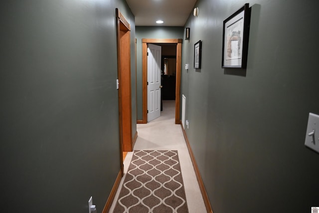 hallway with light colored carpet