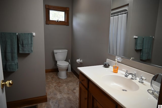 bathroom featuring toilet and vanity