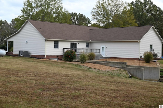 rear view of property with a deck and a lawn