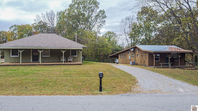 view of front of property with a front lawn, central AC unit, and covered porch