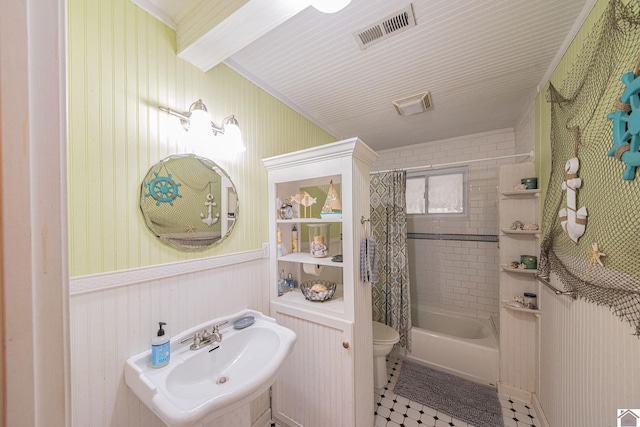 full bathroom featuring tile patterned flooring, sink, toilet, and shower / bathtub combination with curtain