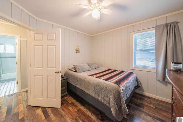 bedroom with dark wood-type flooring, wooden walls, ceiling fan, and crown molding