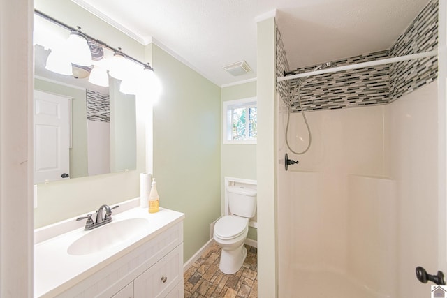 bathroom featuring a shower, vanity, toilet, and crown molding