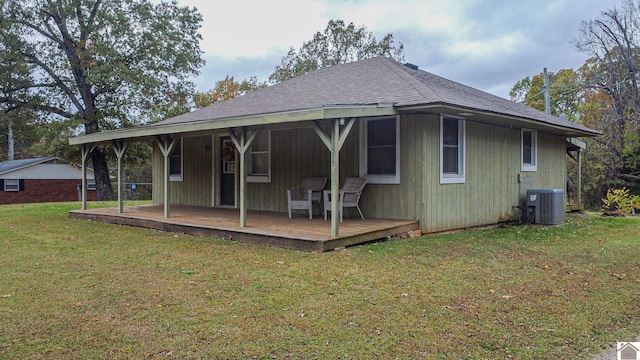 back of property featuring a lawn, a wooden deck, and cooling unit