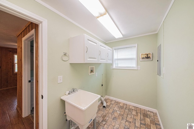 clothes washing area with electric panel, ornamental molding, hookup for a washing machine, dark hardwood / wood-style flooring, and cabinets