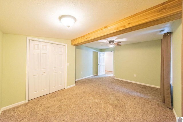 interior space featuring beamed ceiling, a textured ceiling, and ceiling fan