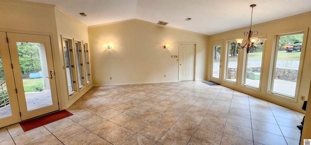 doorway featuring a notable chandelier, light tile patterned flooring, and plenty of natural light