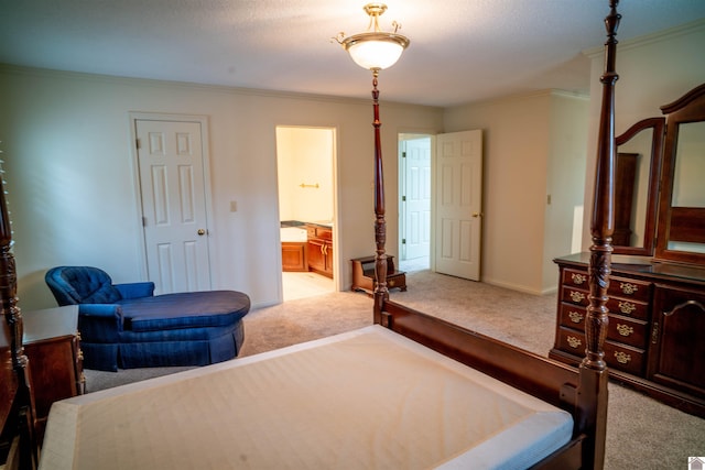 bedroom with a textured ceiling, light colored carpet, ornamental molding, and ensuite bathroom