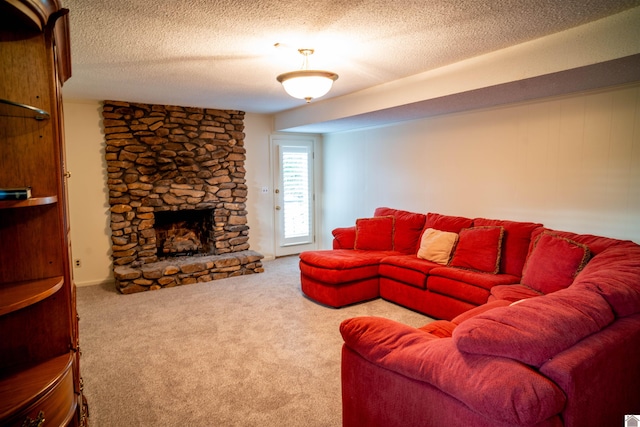 carpeted living room featuring a textured ceiling and a fireplace