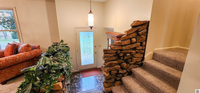 tiled foyer entrance with ornamental molding