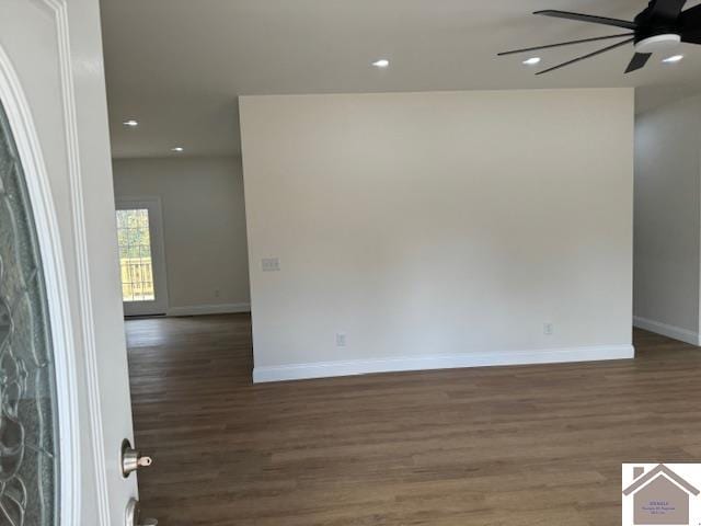 spare room with dark hardwood / wood-style flooring and ceiling fan