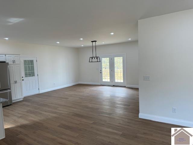 unfurnished living room with dark hardwood / wood-style flooring