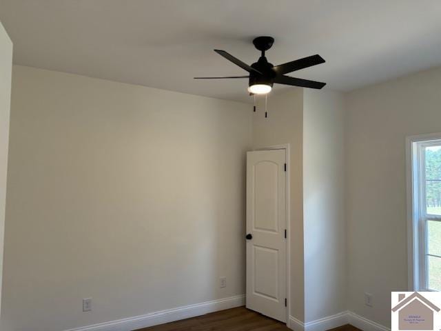 empty room featuring dark hardwood / wood-style flooring and ceiling fan