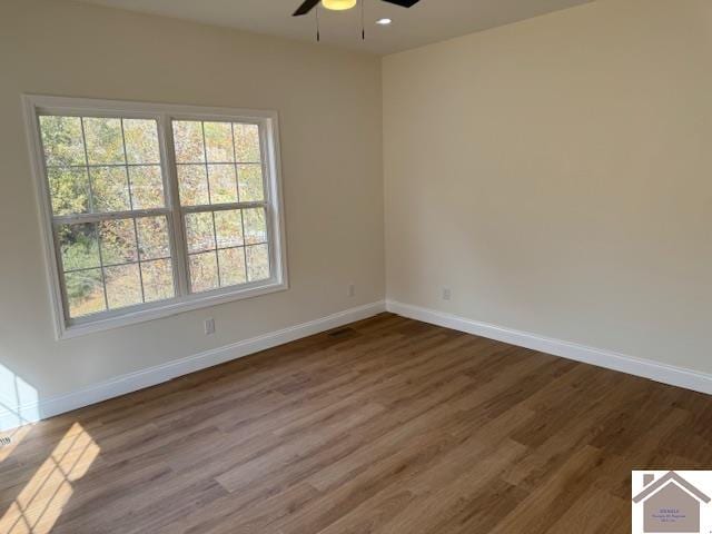 empty room with hardwood / wood-style flooring and ceiling fan