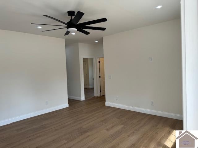 empty room featuring ceiling fan and dark hardwood / wood-style floors