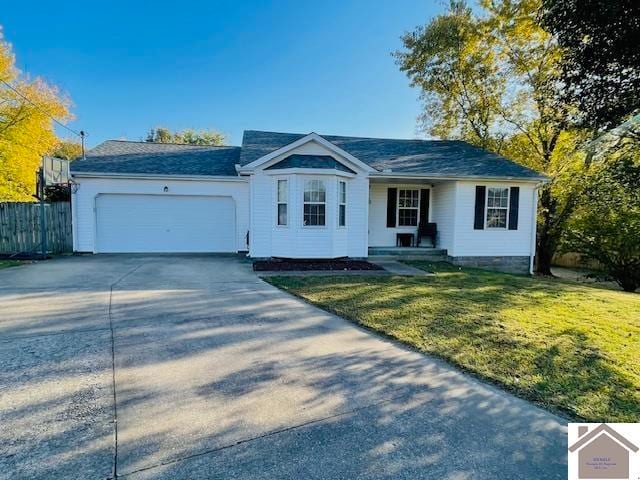 ranch-style house with a garage and a front lawn