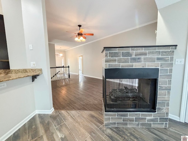 room details featuring hardwood / wood-style floors, a fireplace, ceiling fan, and crown molding