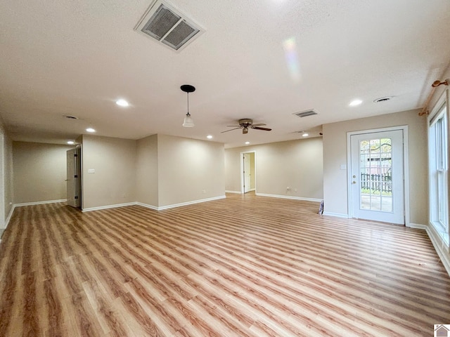 unfurnished room with light hardwood / wood-style flooring and ceiling fan