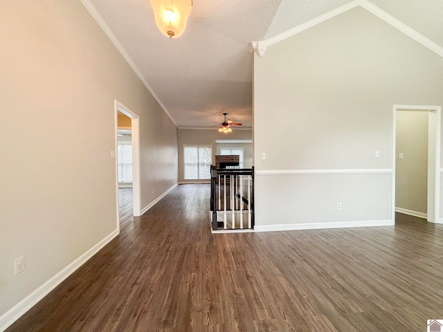 spare room with dark hardwood / wood-style flooring, vaulted ceiling, and ornamental molding