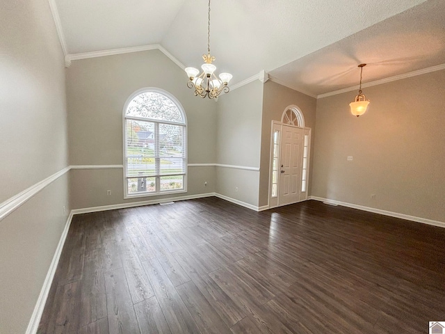 empty room with dark wood-type flooring, vaulted ceiling, an inviting chandelier, and crown molding