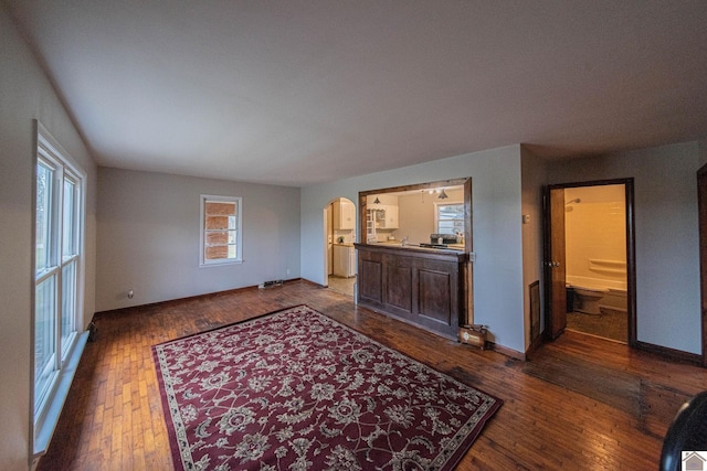 unfurnished living room with dark hardwood / wood-style floors