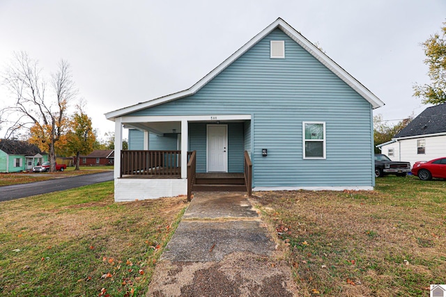 bungalow-style home with a porch and a front lawn