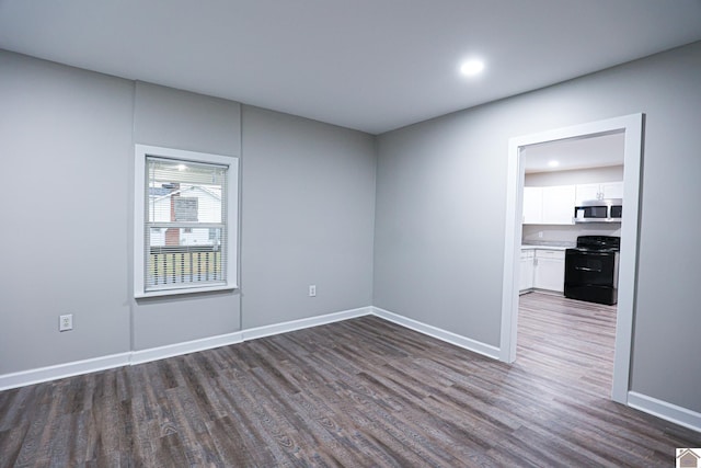 spare room with dark wood-type flooring