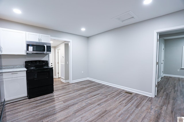 kitchen with white cabinets, light hardwood / wood-style floors, and black range with electric stovetop