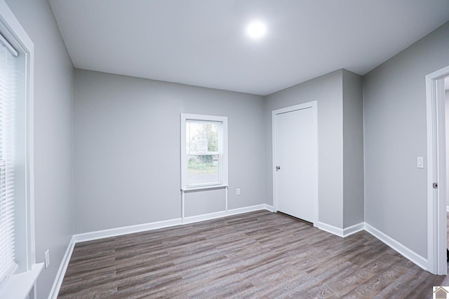 empty room with hardwood / wood-style flooring