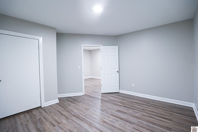 unfurnished bedroom featuring a closet and wood-type flooring