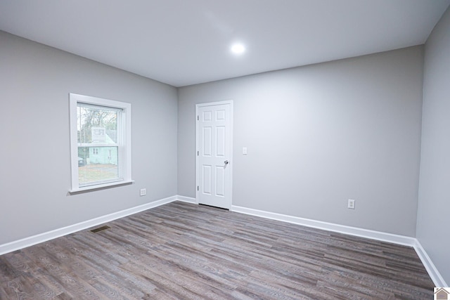 spare room with dark hardwood / wood-style flooring