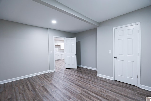 unfurnished room featuring dark wood-type flooring