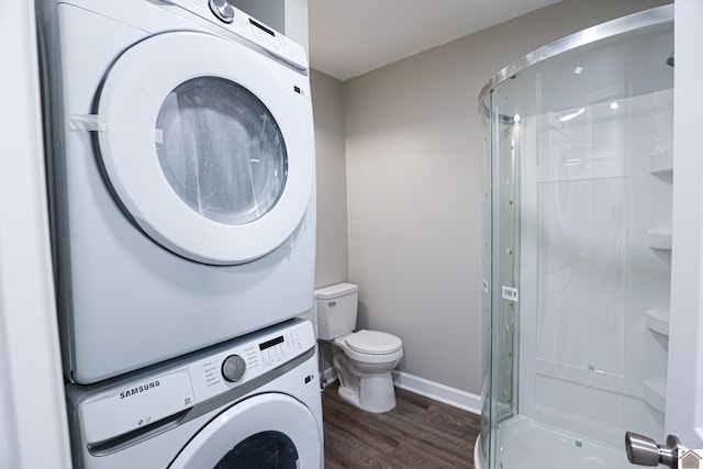 bathroom with stacked washer and dryer, toilet, an enclosed shower, and hardwood / wood-style flooring