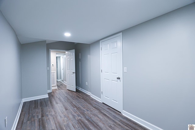 unfurnished bedroom featuring dark hardwood / wood-style flooring