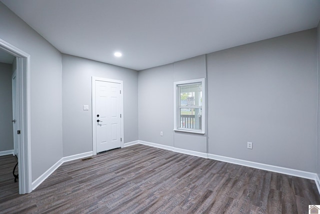 unfurnished room with dark hardwood / wood-style flooring