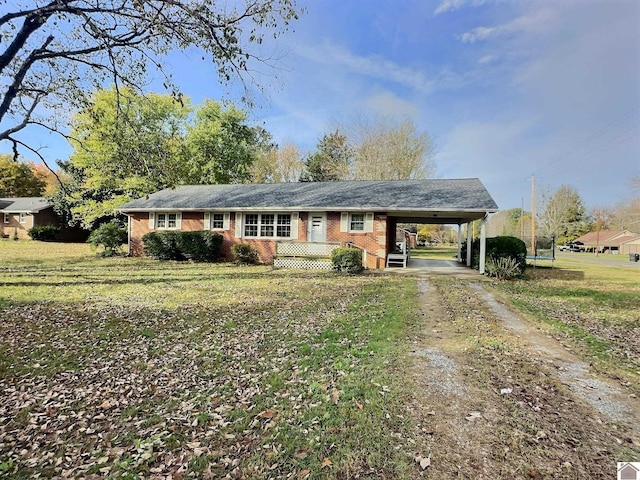 ranch-style house featuring a front yard and a carport