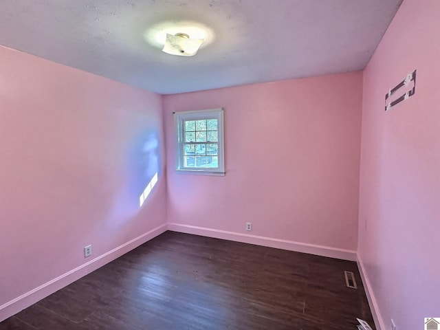 empty room with dark hardwood / wood-style floors